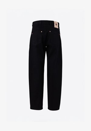 Black denim trousers featuring a loose fit, two back pockets, copper rivets, and a branded leather patch at the waistband.