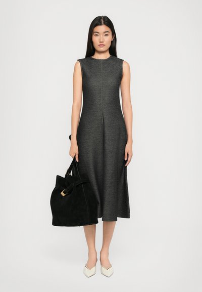 Sleeveless gray dress with a fitted bodice and flared skirt, paired with a black suede handbag featuring a buckle and white pointed flats.