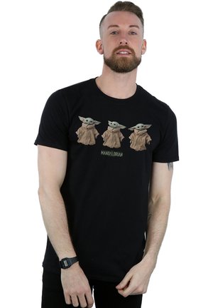 Black cotton t-shirt featuring a graphic of three characters with large ears in brown robes. Text below reads "Mandalorian."