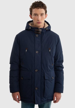 Navy zīda parka jakas ar kapuci, diviem krūškurvja kabatām un brūniem akcentiem, ar priekšējo rāvējslēdzēju un pogu aizdari.
