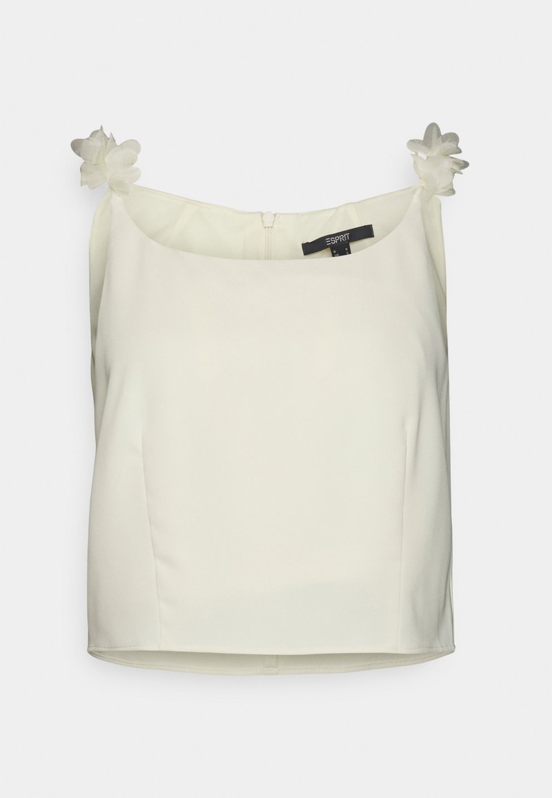 Top cropped branco, sem mangas, feito de um tecido suave. Apresenta dois apliques de flores nas alças e um fecho de zíper nas costas.