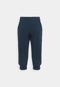 Calças de moletom azul-marinho com um cós elástico, punhos ajustados e um tecido leve e suave. Design simples sem embellishments.
