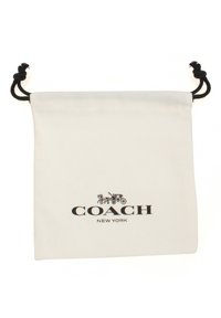Cotton drawstring bag in white with black hardware. Features a printed logo "COACH NEW YORK" and an illustration of a horse-drawn carriage.