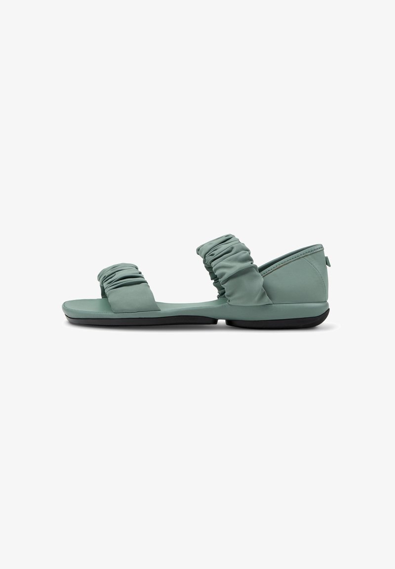 Green foam sandals feature two ruched fabric straps, a flat sole with a slight contour, and a minimalist design.