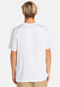White cotton T-shirt with short sleeves, crew neckline, and a relaxed fit. Smooth texture with no patterns or visible hardware.