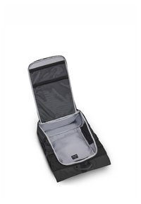 Black backpack with a gray interior. Features an open main compartment and two mesh zip pockets on the lid for organization.