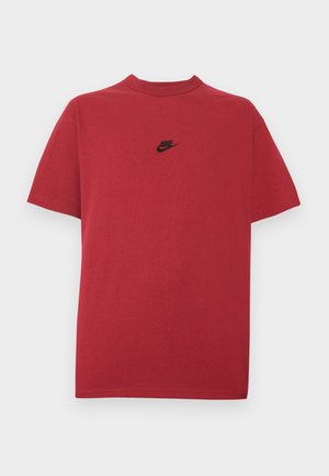 Punainen puuvillainen t-paita, jossa on musta Nike-logo rinnassa, lyhyet hihat, pyöreä pääntie ja normaali istuvuus. Sileä rakenne.