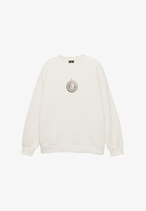 Biela dlhá mikina s dlhým rukávom, okrúhlym výstrihom a malou grafiku okrúhleho pendantu so psou tvárou v centre prednej časti.