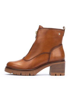 Brown leather ankle boot with a side zipper, rounded toe, and a stacked block heel. Features textured matte finish and subtle stitching detail.