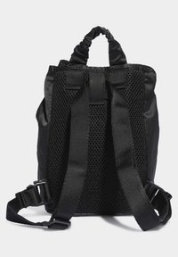 Black backpack with a textured mesh back, elastic carrying handle, and adjustable straps. Made from durable fabric with a minimal design.