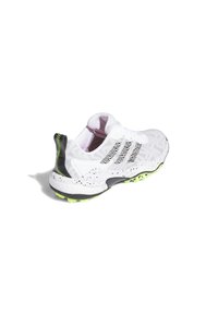 White athletic shoe with mesh upper, black heel accent, and yellow-green rubber sole. Features textured design and reflective laces.