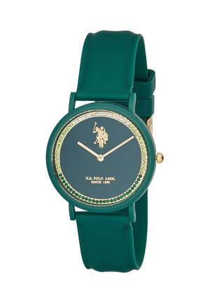 Orologio da polso verde con quadrante rotondo, lancette dorate, logo U.S. Polo Assn. e motivo circolare di cristalli verdi e trasparenti sul quadrante.