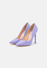 Lilac high-heeled pumps with a pointed toe design, smooth matte finish, and slender heel. Interior is beige with a subtle brand label.