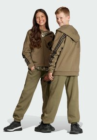 adidas Performance FUTURE ICON - Pantalones deportivos - olive strata   black