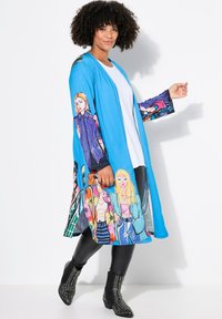 Blue kimono-style outerwear featuring colorful fashion illustrations on sleeves and bottom, paired with black leggings and studded ankle boots.
