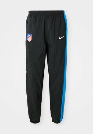 Black windbreak pants with blue side stripes, featuring a team logo and a Nike swoosh. Elastic waistband and cuffed hems. Lightweight material.