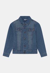 Jeansjacke in Mittelblau mit zwei Fronttaschen, Knopfverschluss und klassischem Kragen. Abgenutzte Textur an Ärmeln und Körper.