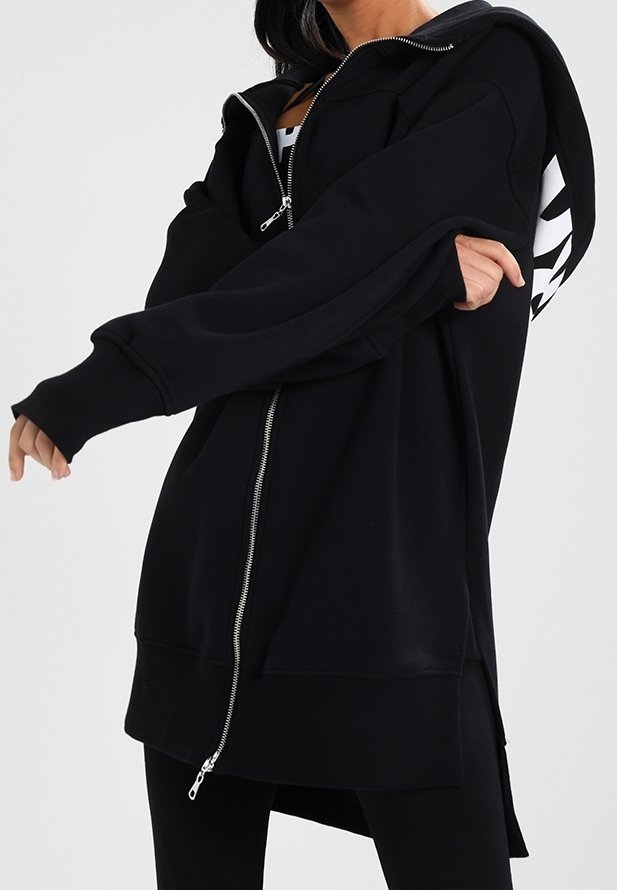 Black zip-up hoodie made of soft fabric, featuring a relaxed fit, oversized design, long sleeves, and a side zipper detail.