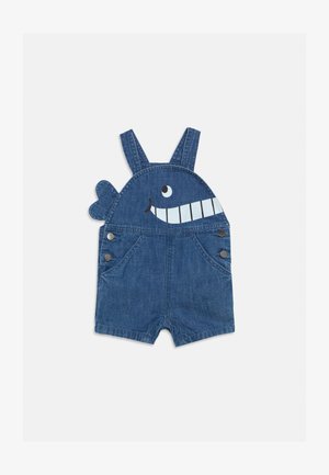 Denim toddler overalls with a smiling whale face and tail fin detail on the bib, featuring adjustable shoulder straps and side button closures.
