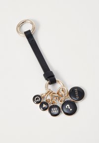 Sorte læder nøglering med en guldring og fem dekorative sorte charms med præget tekst, herunder "GUESS" og "EST 1981."