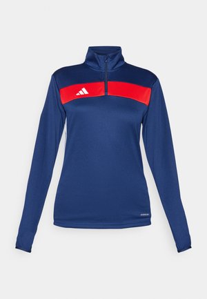 Jūrų laivyno ilgomis rankovėmis ketvirčio užtrauktuku megztinis, aprašytas raudona horizontalia juosta, balta logotipu, lygia tekstūra ir prigludusia forma. Funkcionali medžiaga.