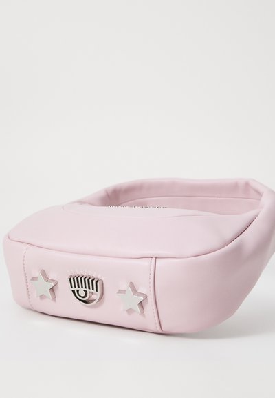 Rosa faux lærveske med rund form. Har sølvstjerneakenter og et sentralt øye-design på forsiden. Glatt tekstur og minimalistisk design.