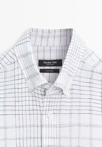 White button-up shirt with black grid pattern, buttoned collar, and "Massimo Dutti" label sewn inside the neckline.