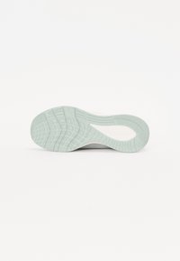 Suola di scarpa da atletica con una superficie in gomma verde menta chiaro e texture. Presenta un battistrada decorato per una presa e un supporto ottimali, con contorni arrotondati.