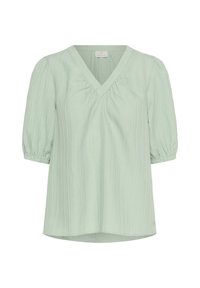 Blouse texturée vert clair avec décolleté en V, manches courtes bouffantes et fronces subtiles sous le col.