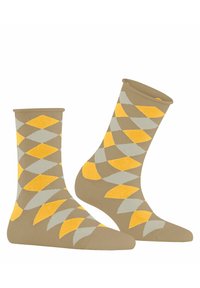 Beige Socken mit einem Rautenmuster in Gelb und Grau. Hergestellt aus einem weichen Material, mit einem gerippten Bündchen und verstärktem Zehenbereich.