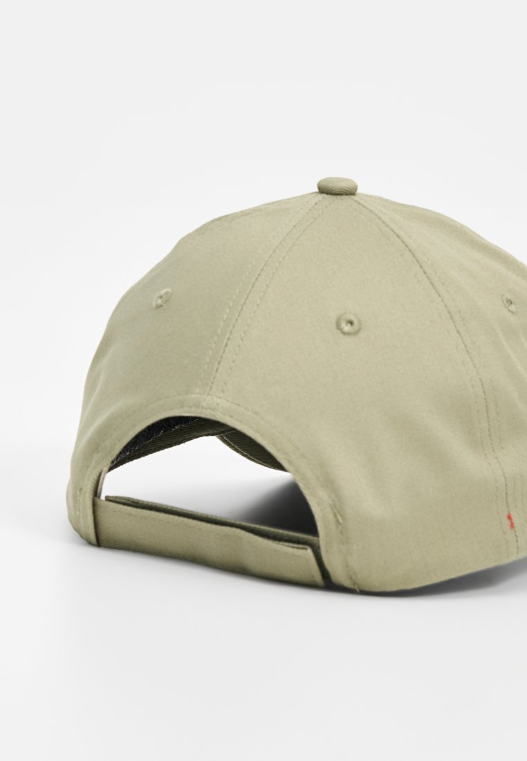 Gorra de béisbol color caqui con seis paneles, una corona redondeada y una correa en la parte trasera para ajuste. Material de algodón con detalles bordados.