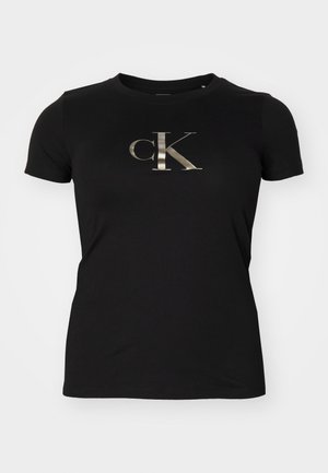 Černé bavlněné tričko s metalicky stříbrným logem "ck" na přední straně. Krátké rukávy a kulatý výstřih. Hladká textura.