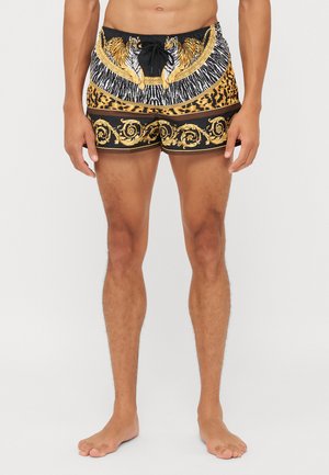 Swim shorts featuring a black base with gold and tiger print designs, textured waistband, and a drawstring for adjustment.