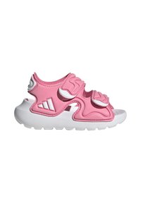Różowe sandały z miękką gumową cholewką, regulowanymi paskami i białymi akcentami. Podeszwa jest biała i teksturowana dla lepszej przyczepności. Lekka konstrukcja i otwarty design.