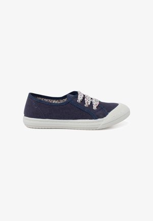 Navy canvas sneakers with white rubber soles, patterned laces, and floral lining. Features a rounded toe and stitching accents.