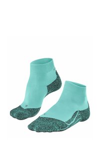 Turkusowe skarpetki do kostek z teksturowaną czarną podeszwą, wyeksponowane w parach, podkreślające ich sportowy design i żywy kolor.