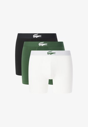 Tre boxer da uomo in nero, verde e bianco, ciascuno con un logo coccodrillo a contrasto sulla fascia in vita.