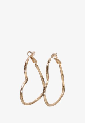 Pendientes de aro en tono dorado con un diseño ondulado e irregular. Fabricados en metal con un acabado brillante y cierre de seguridad.