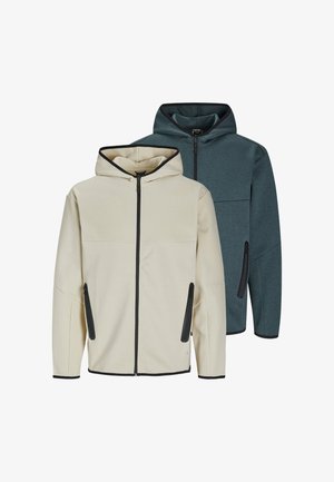 Un paio di giacche con cappuccio in beige e verde scuro, dotate di tasche frontali con cerniera e accenti neri a contrasto. Realizzate in un morbido tessuto misto.