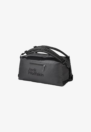 Black duffel bag with adjustable straps, a front zipper pocket, and large logo. Made of durable fabric, featuring a rectangular shape.
