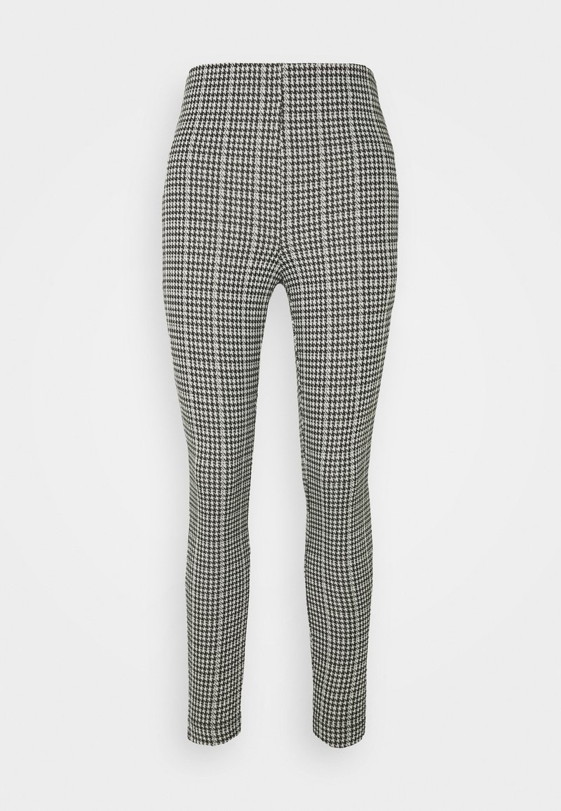 Svarta och vita byxor med hundtandmönster, med en åtsittande design, avsmalnande ben och en mjuk tygkänsla. Elastisk midja, inga knäppningar.