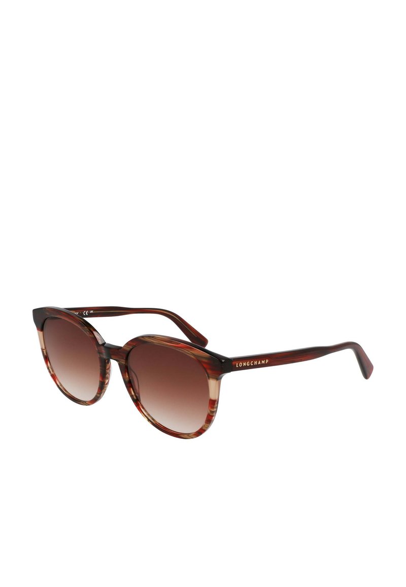 Round sunglasses with a tortoiseshell pattern, gradient brown lenses, and a black temple featuring 'LONGCHAMP' in gold lettering.