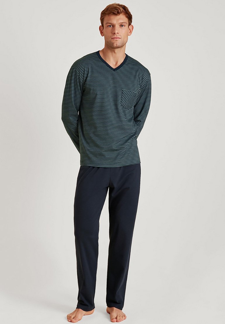 Men's loungewear set featuring a navy striped long-sleeve top with a pocket and matching solid navy pants, made from soft fabric.