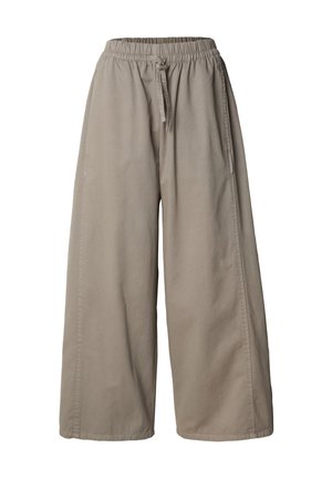 Bézs színű, bőszárú nadrág gumis derékrésszel és húzózsinórral, oldalvarrásos részletekkel és laza szabással.