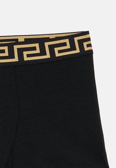 Fekete rugalmas derékrész arany görög mintával. Az anyag sima és rugalmas, a kényelem és a tökéletes illeszkedés érdekében készült.