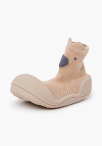 Beige stoffen sok met een gestructureerde zool, voorzien van een donkergrijs dierengezicht ontwerp en een ribbelboord voor een goede pasvorm.