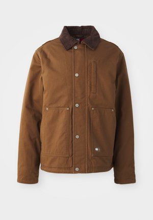 Brown cotton jacket with a corduroy collar, snap buttons, two front pockets, a chest pocket, and a small logo detail on the hem.