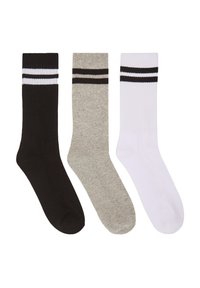 Tre paia di calze da crew in nero, grigio e bianco. Ogni calza presenta una texture a coste e due righe nere orizzontali nella parte superiore.