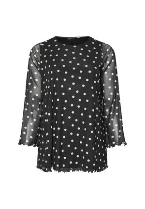 Black top with white polka dots. Sheer long sleeves, round neckline, and frilled cuffs. Relaxed fit and lightweight fabric.