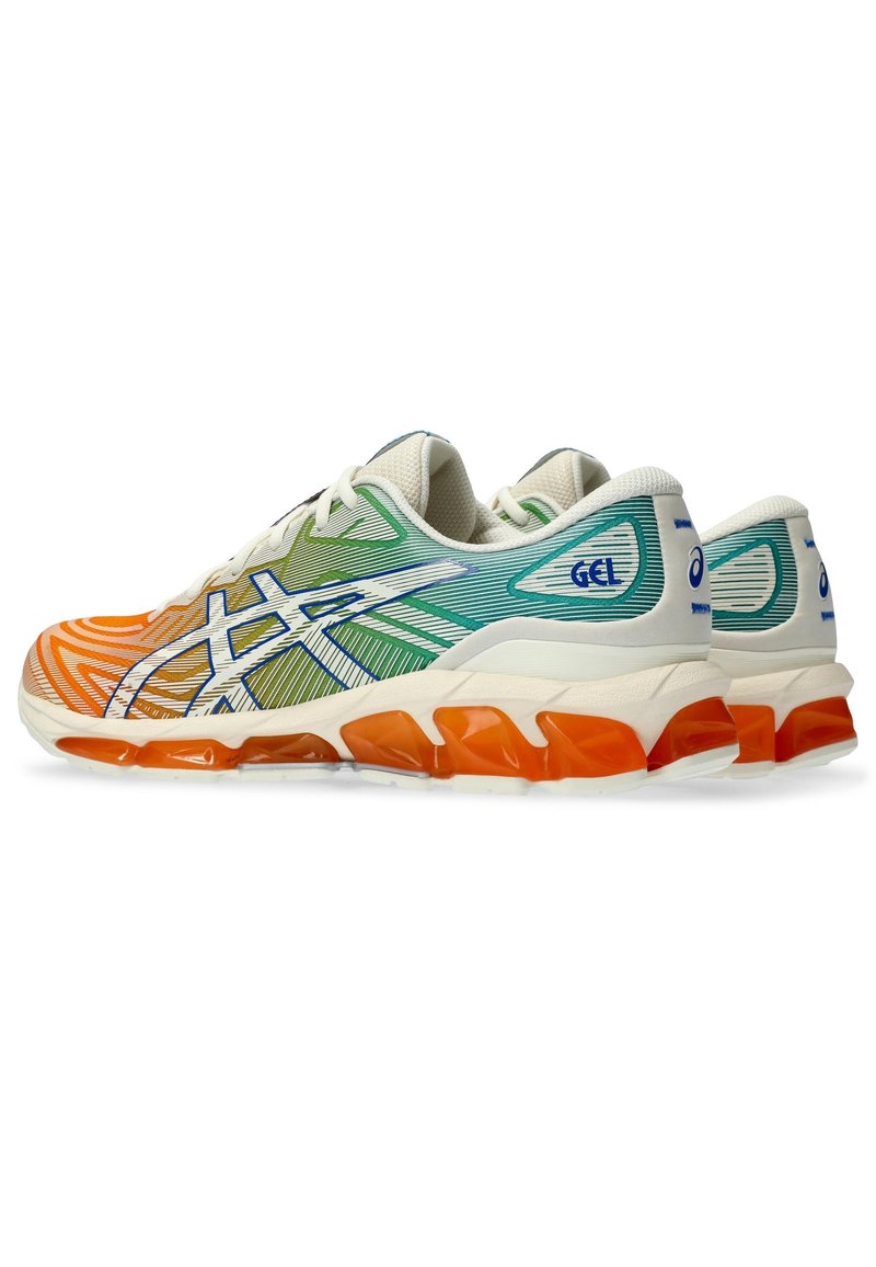 Running shoes with a multicolored upper featuring green, blue, orange, and white patterns, and a chunky orange sole with gel cushioning.